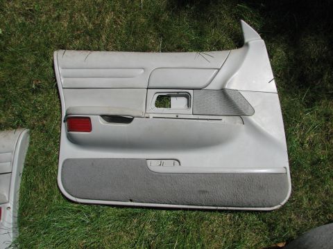 1999 Ford Crown Victoria - Car door panel part shown on grass, not a complete vehicle.