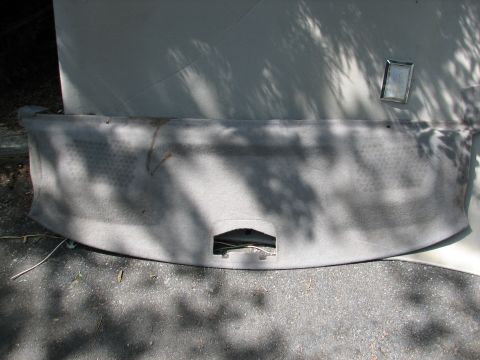1999 Ford Crown Victoria - A detached car headliner is shown outdoors, resting on asphalt with shadows from trees overhead.