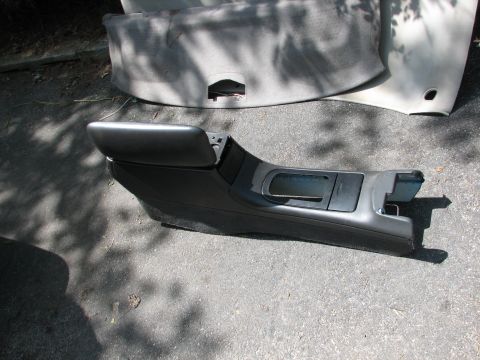 1999 Ford Crown Victoria - A car's center console with an armrest and storage is shown removed from the vehicle.