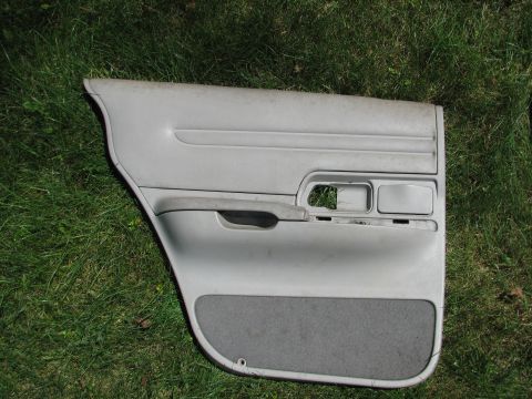 1999 Ford Crown Victoria - Car door panel with fabric insert shown on grass.
