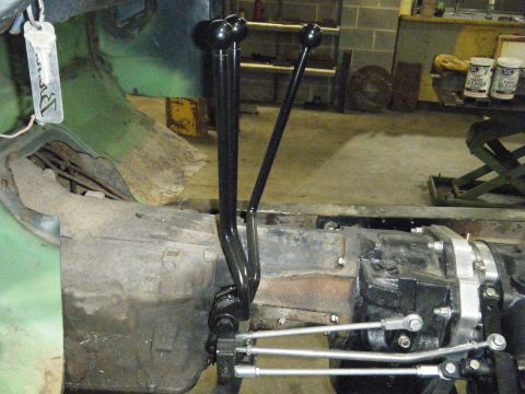 1978 Ford Bronco - Transfer case and shifter levers in a workshop setting.