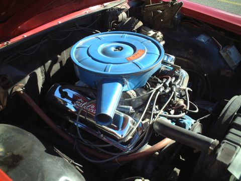1967 Ford Galaxie - Engine bay of a 1967 Ford Galaxie, a blue air cleaner assembly and chrome Edelbrock valve covers.