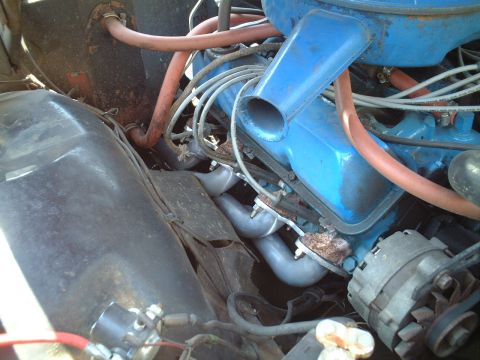 1967 Ford Galaxie - Close-up view of an engine bay, highlighting the exhaust headers and various engine components.