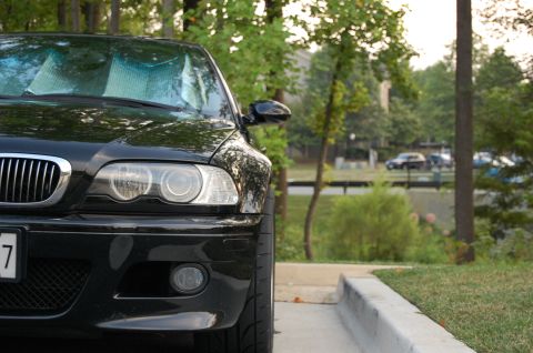 2002 BMW M3 - Front view of a black BMW M3, identified as a 2002 model based on grille design.