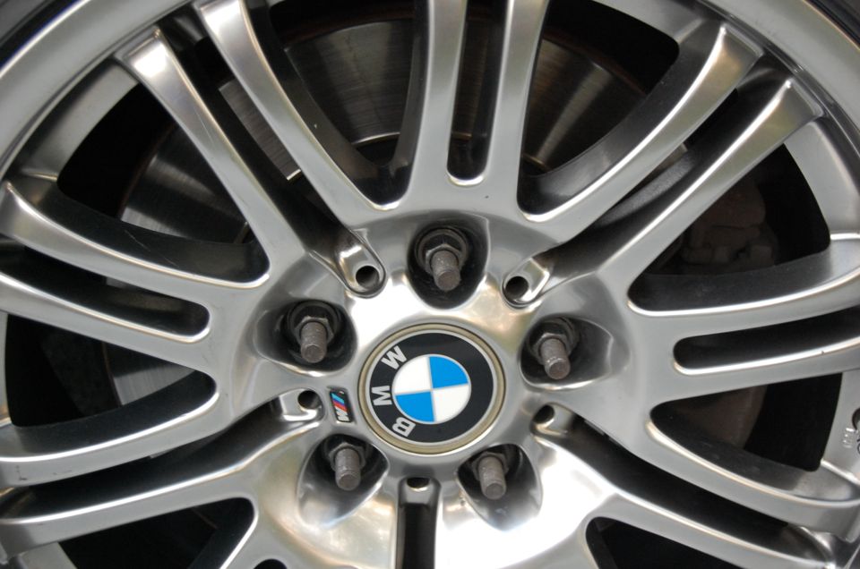 Close-up of a BMW alloy wheel showing the center cap with BMW logo and M badge