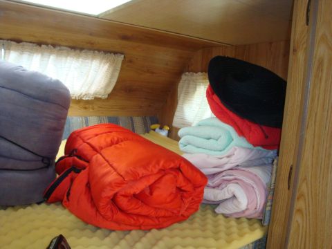 1988 Ford F-350 - Camper interior with sleeping bags and blankets ready for use.