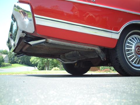 1967 Ford Galaxie - Underside view of a red 1967 Ford Galaxie's dual exhaust system and rear bumper.