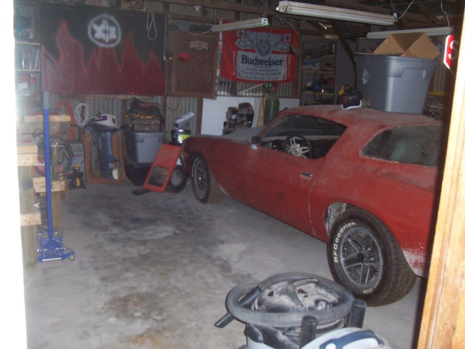 Red coupe in a garage, side view