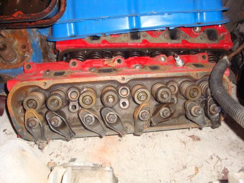 1989 Ford Bronco - Close-up view of an engine's cylinder head, showing internal components like rocker arms and valves.