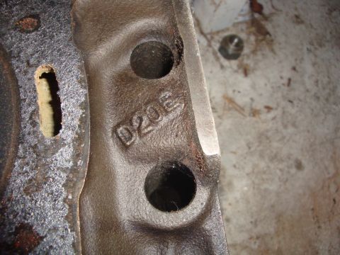 1989 Ford Bronco - A close-up view of a metal casting with the characters D20E imprinted on its surface.
