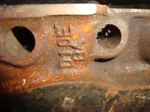 1989 Ford Bronco - Close-up of a heavily rusted engine component showing embossed lettering.
