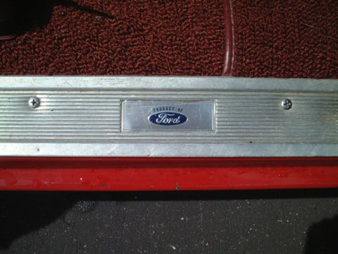 1967 Ford Galaxie - A metal door sill plate with the Ford logo is visible on the interior of a vehicle.