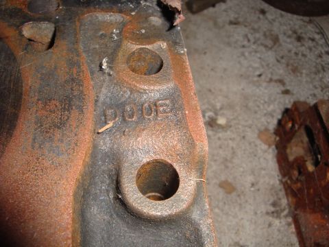 1989 Ford Bronco - Close-up of a heavily rusted engine part with visible stamped lettering.