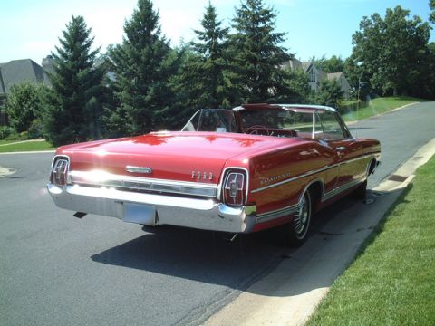 1967 Ford Galaxie - This red 1967 Ford Galaxie convertible is shown from the rear, parked on a suburban street.