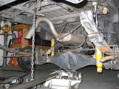 1990 Toyota Pickup/SR5 - Close-up view of a vehicle's rear axle and suspension components during maintenance.