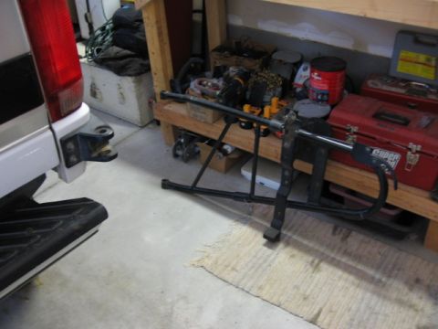 1995 Ford Bronco - A frame mount drop down tire carrier is shown in a garage setting.