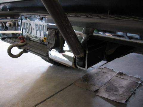 1995 Ford Bronco - Close-up of a trailer hitch assembly with a Colorado license plate and tow hook attached.