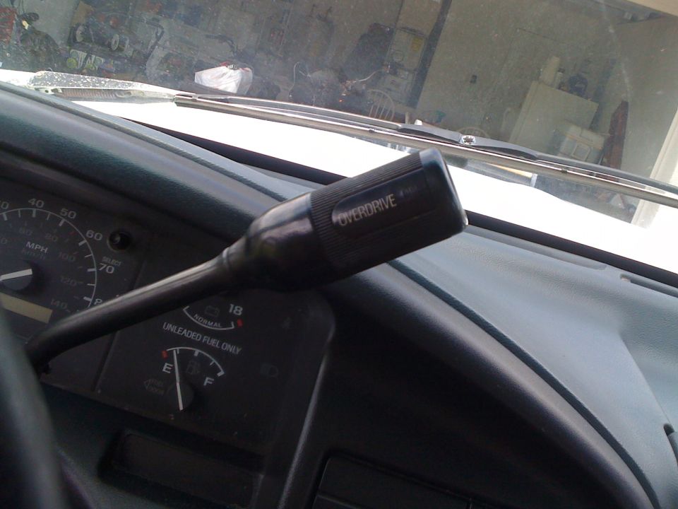 Column shifter labeled OVERDRIVE and gauge cluster inside a 1993 Ford F-150 cab