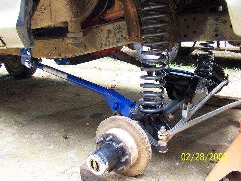 1979 Ford F-150 - Close-up of truck suspension components, including a blue control arm and brake assembly.