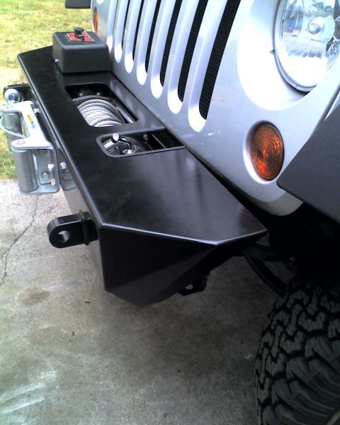 2005 Jeep Wrangler - A black aftermarket bumper with a winch is attached to the front of a silver Jeep Wrangler.
