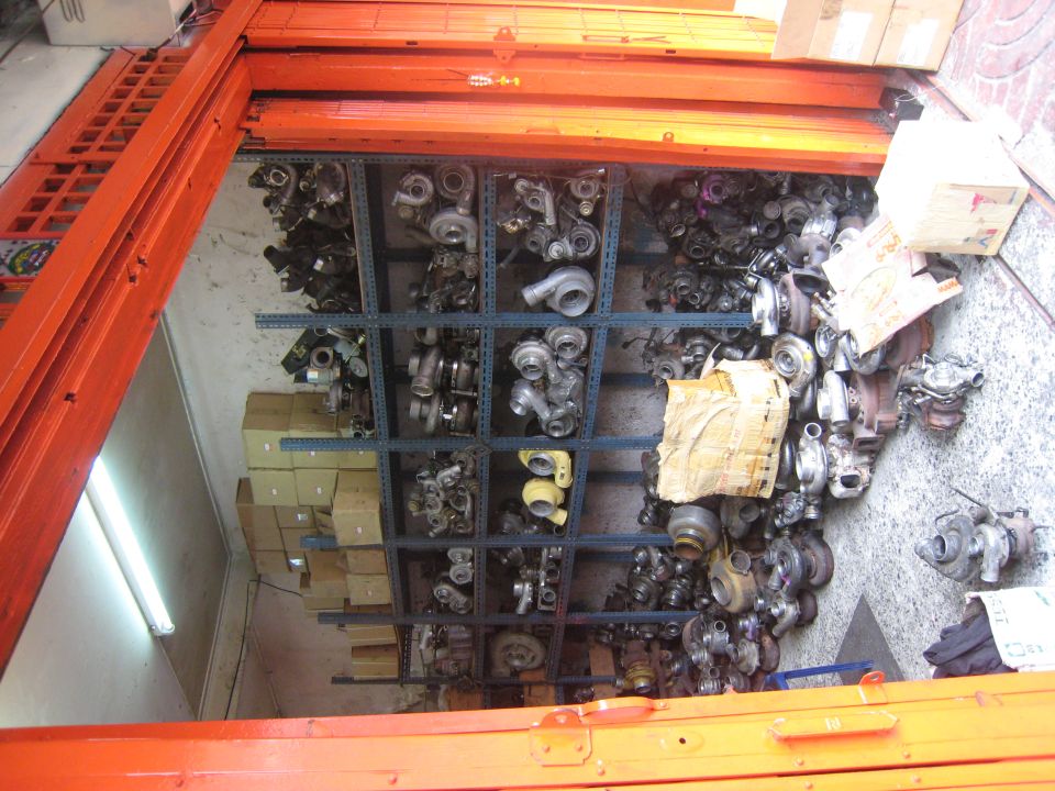 Shelves of used turbochargers in a parts warehouse, rotated view
