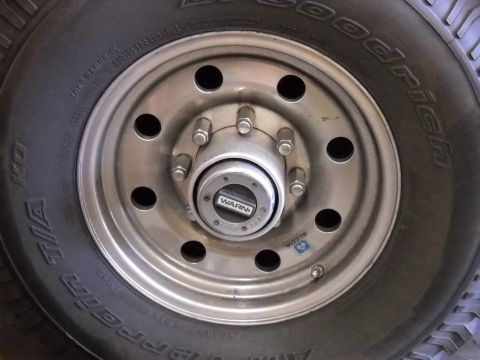 1996 Ford F-250 - A close-up view of a BFGoodrich All-Terrain T/A tire and a wheel with a Warn locking hub.