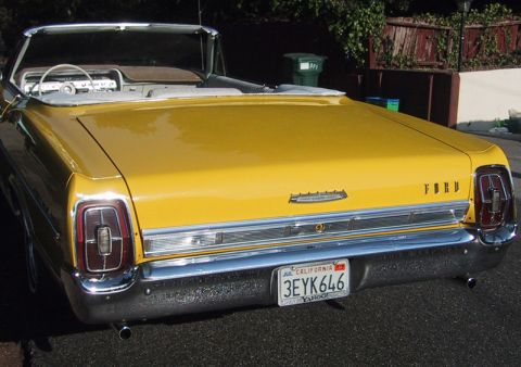 1967 Ford Galaxie - Rear view of a yellow 1967 Ford Galaxie convertible with a white interior and California license plate.