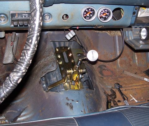 1971 Ford Ranchero - Aftermarket shifter and gauges installed in a car's interior.