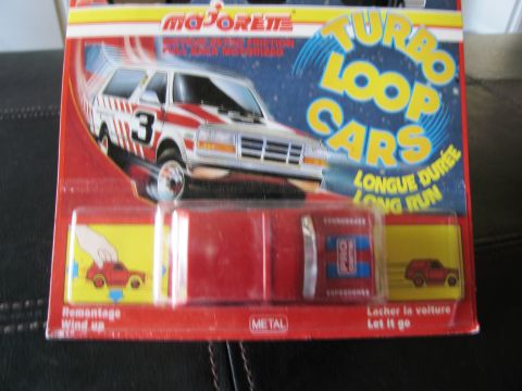 1986 Ford Bronco - This Majorette Turbo Loop Cars diecast toy features a red vehicle with racing stripes and the number 3 on its side.
