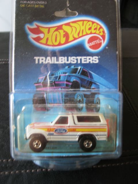 1986 Ford Bronco - A white 1986 Ford Bronco toy, part of the Hot Wheels Trailbuster series, is displayed in its original packaging.