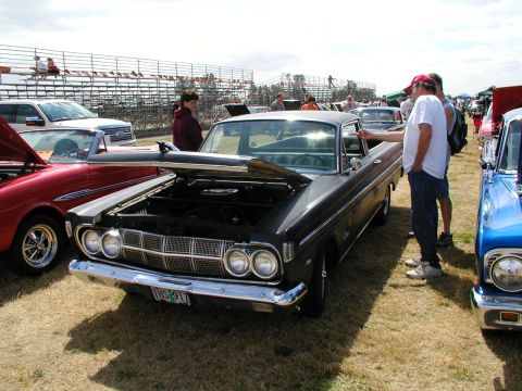 1967 Ford Ranchero - 1967 Ford Ranchero on display at a car show, hood raised to reveal the engine bay.