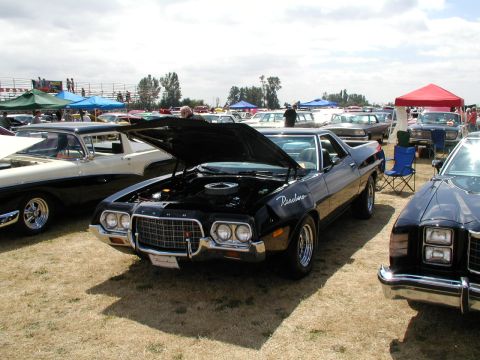 1967 Ford Ranchero - A black 1972 Ford Ranchero is displayed with its hood open at an outdoor car show.