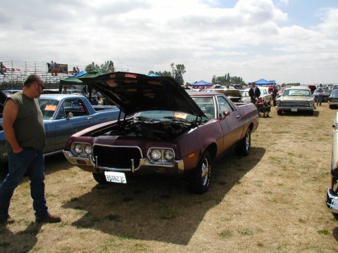 1967 Ford Ranchero - Maroon 1972 Ford Ranchero at a car show, hood up, with other vehicles around.