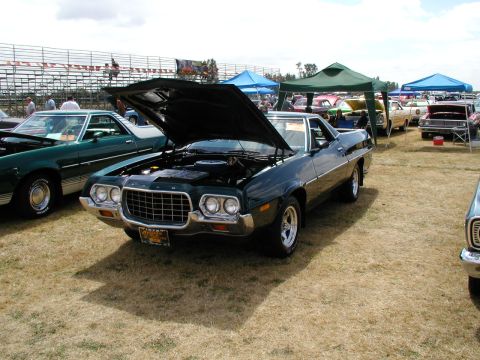 1967 Ford Ranchero - A dark green 1972 Ford Ranchero is displayed with its hood open at a car show.