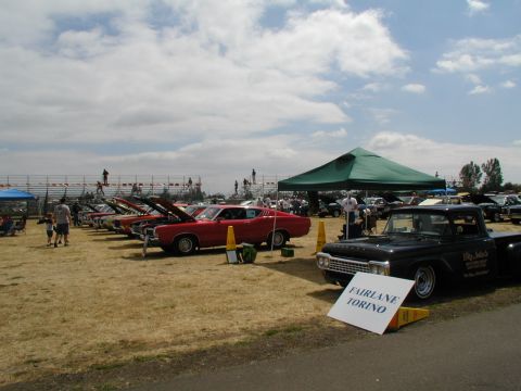 1967 Ford Ranchero - A 1959 Ford pickup truck is displayed at a car show alongside other classic vehicles.