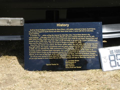 1967 Ford Ranchero - A sign details the history of a car, next to a US Forces license plate.