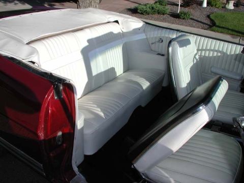 1967 Ford Galaxie - The interior of a 1967 Ford Galaxie convertible features white vinyl seats and a red exterior.