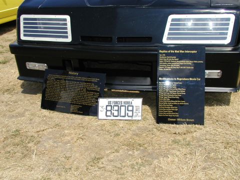 1967 Ford Ranchero - Replica Mad Max Interceptor car on display with detailed history and modification information signs.