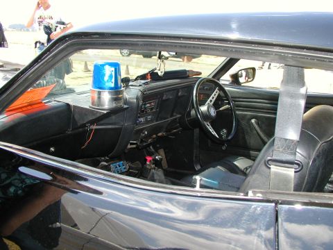 1967 Ford Ranchero - The interior of a black vehicle shows a blue light mounted on the dashboard.