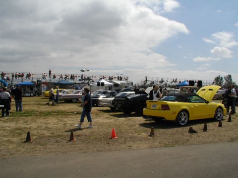 1967 Ford Ranchero - Several cars are on display at an outdoor event, with spectators in the background.