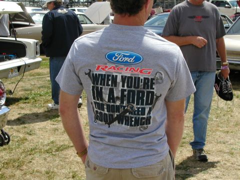 1967 Ford Ranchero - A man wears a Ford Racing t-shirt at an outdoor car event with other vehicles and people visible.