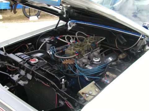 1967 Ford Ranchero - The engine bay of a 1967 Ford Ranchero features a dual carburetor setup and custom blue wiring.