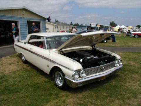 1967 Ford Ranchero - A white 1961 Ford Falcon Ranchero is displayed with its hood open at an outdoor car show.