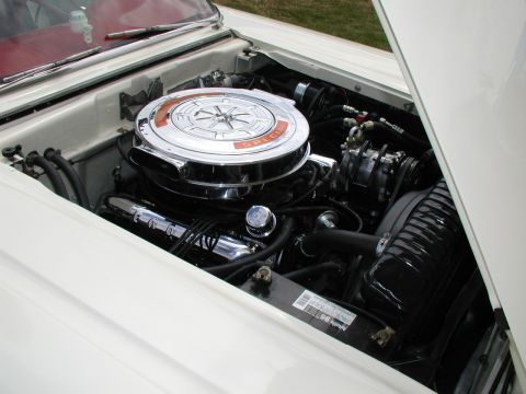 1967 Ford Ranchero - The engine bay of a 1967 Ford Ranchero features a prominent chrome air cleaner and a V8 engine, indicating a classic American pickup truck.