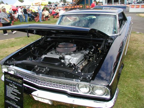 1967 Ford Ranchero - 1963 Ford Galaxie Z on display at a car show, engine compartment open.