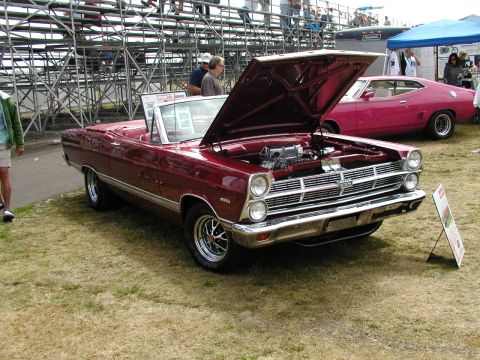 1967 Ford Ranchero - A maroon 1967 Ford Fairlane convertible is displayed with its hood open at an outdoor event.
