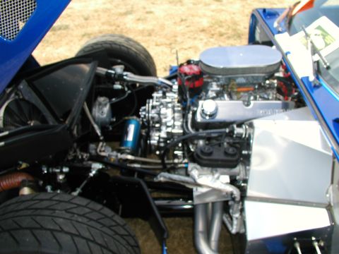1967 Ford Ranchero - The engine bay of a blue vehicle is shown with a V8 engine and chrome accents.