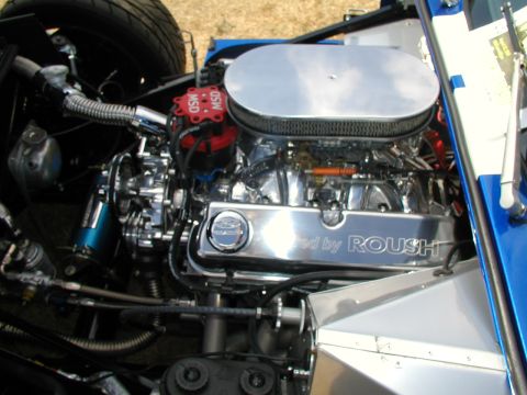 1967 Ford Ranchero - Custom V8 engine bay a chrome air cleaner and valve covers reading "Powered by ROUSH".