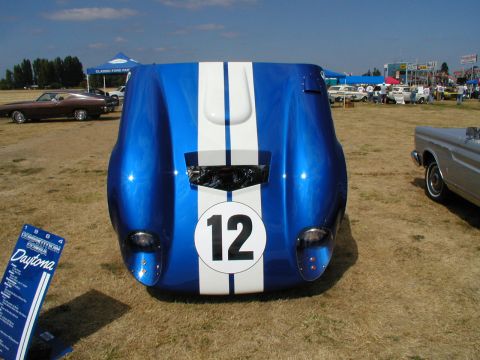 1967 Ford Ranchero - Race car front end with number 12 on display at a car show.