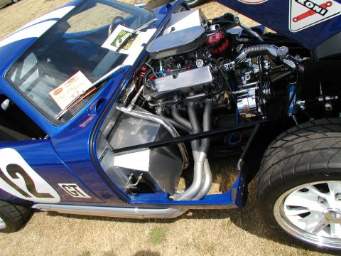 1967 Ford Ranchero - A blue race car with its hood open, revealing a powerful V8 engine and custom exhaust headers.
